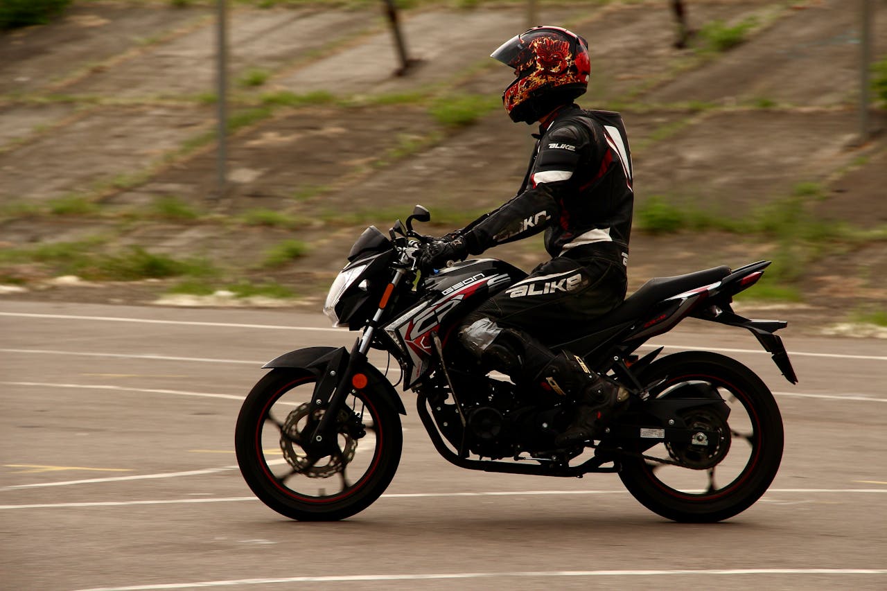 The Art of Drawing Readers In: Your attractive post title goes here A motorcyclist in protective gear riding a sport bike on an urban street during the day.